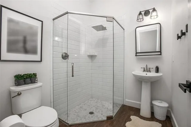 a bathroom with a sink mirror toilet and shower