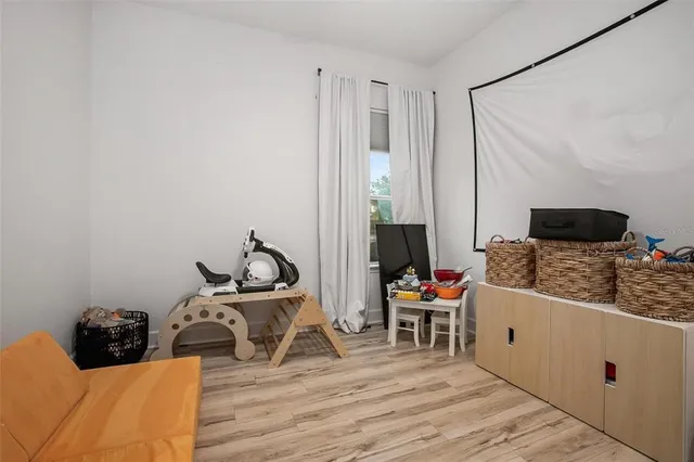 a bedroom with furniture and a flat screen tv