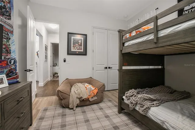 a bedroom with a bed and a tv on the dresser