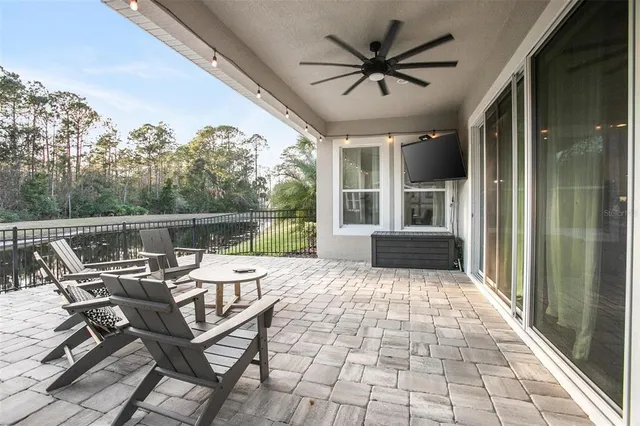 a balcony with furniture and a large window