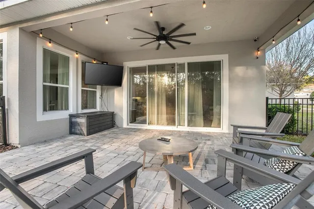 a living room with furniture a window and a chandelier
