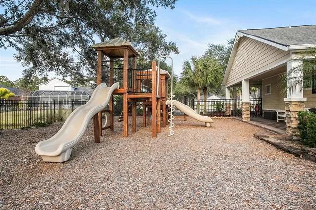 a view of outdoor space with playground and green space