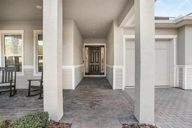 a view of a livingroom with wooden floor and stairs