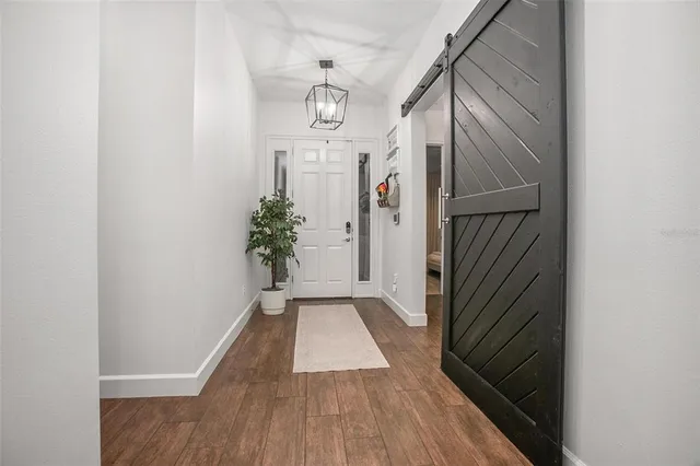 a view of a hallway view with wooden floor and staircase