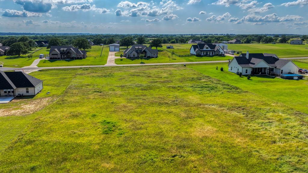 2013 Swallowtail Court Poolville, TX 76487 - Photo 11 of 12 a view of a swimming pool in a yard with lawn chairs