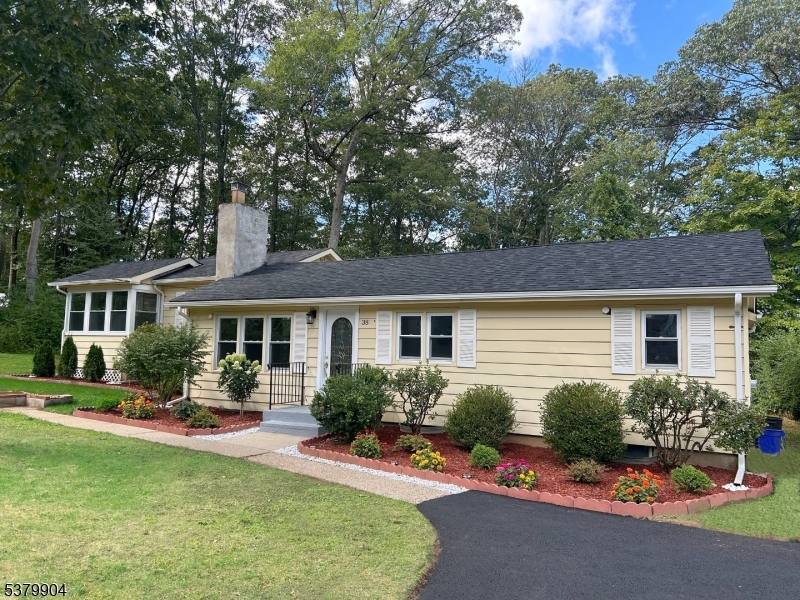 a front view of a house with a yard and porch