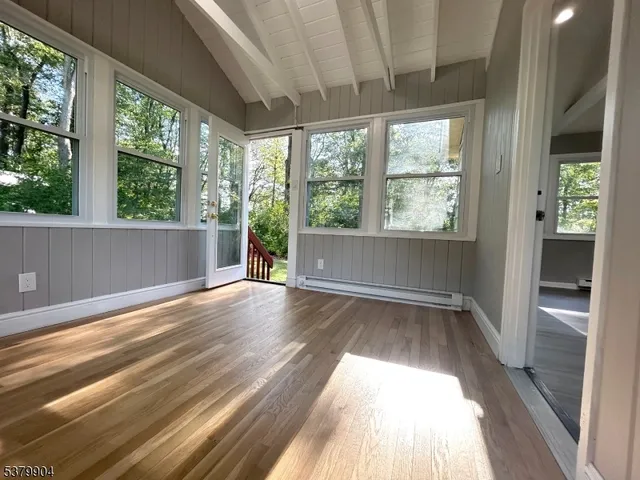 a view of a living room and wooden floor