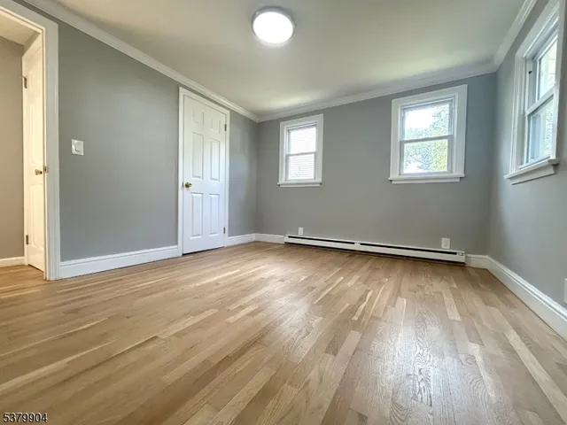 a bathroom with a shower a mirror and a sink