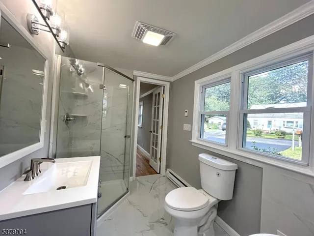 a white bath tub sitting next to a toilet