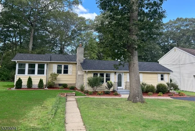 a front view of a house with a yard table and chairs