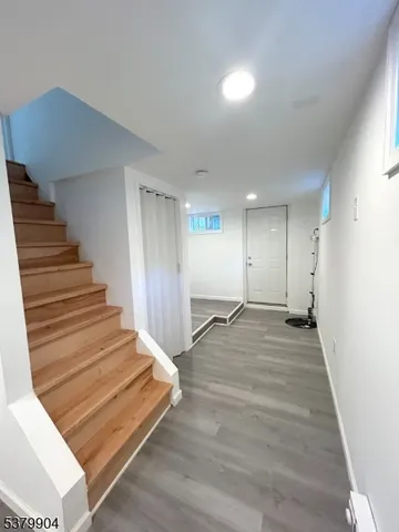 a room with wooden floor and white walls