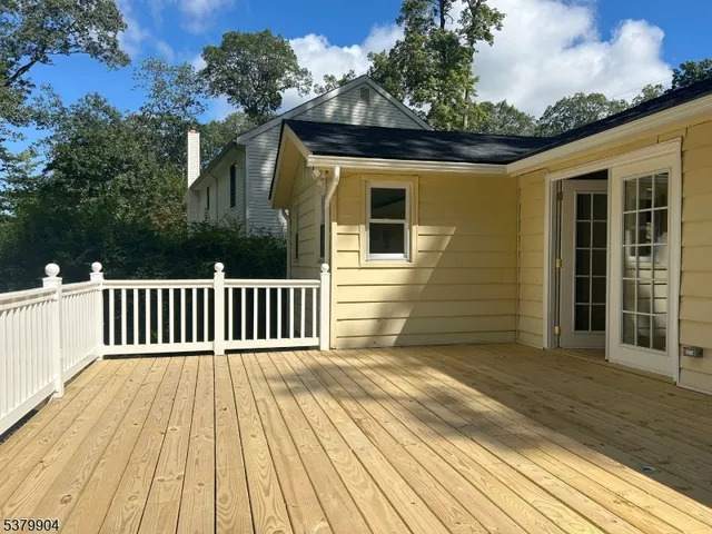 a view of a deck with a bench and wooden fence