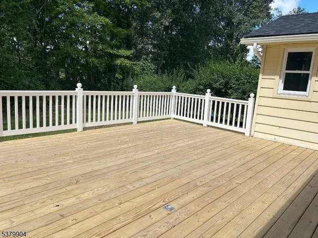 a front view of a house with a garden and yard