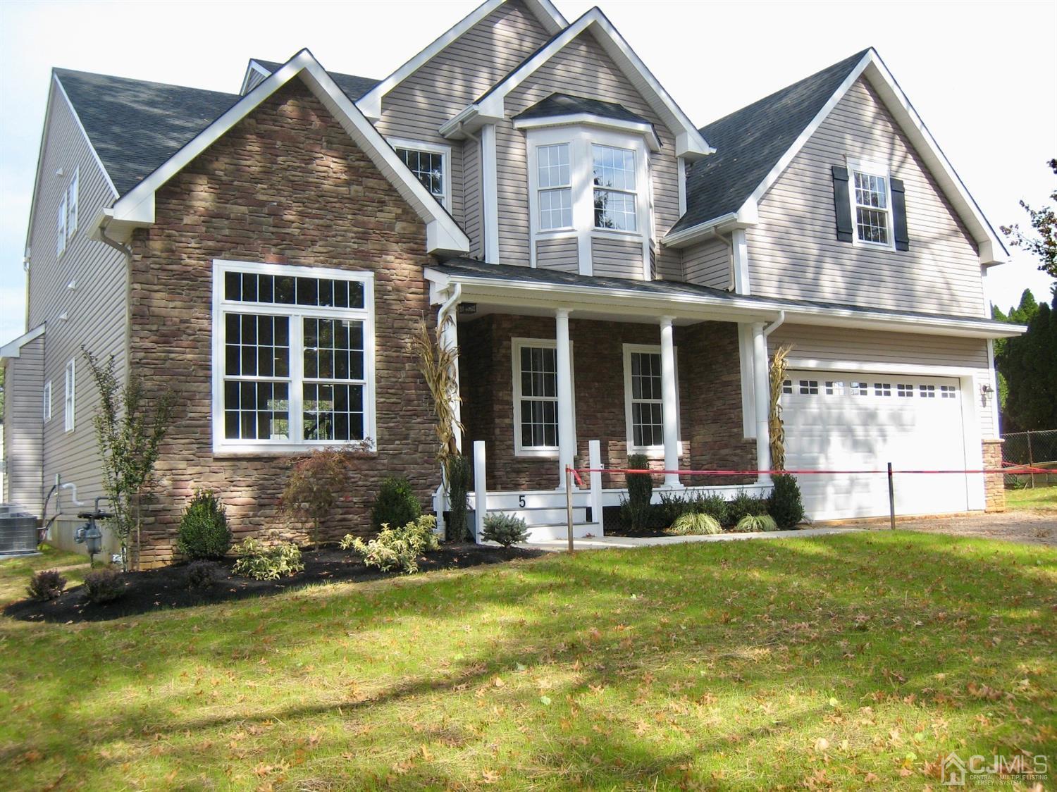 a front view of a house with a yard table and chairs