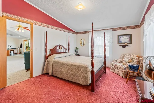 a bedroom with a bed and a mirror