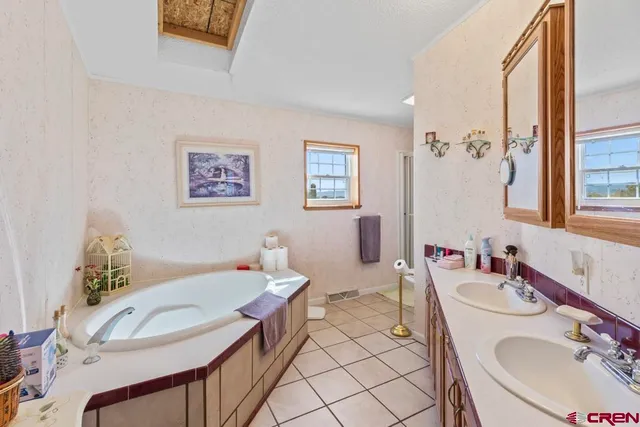 a bathroom with a sink mirror and a table