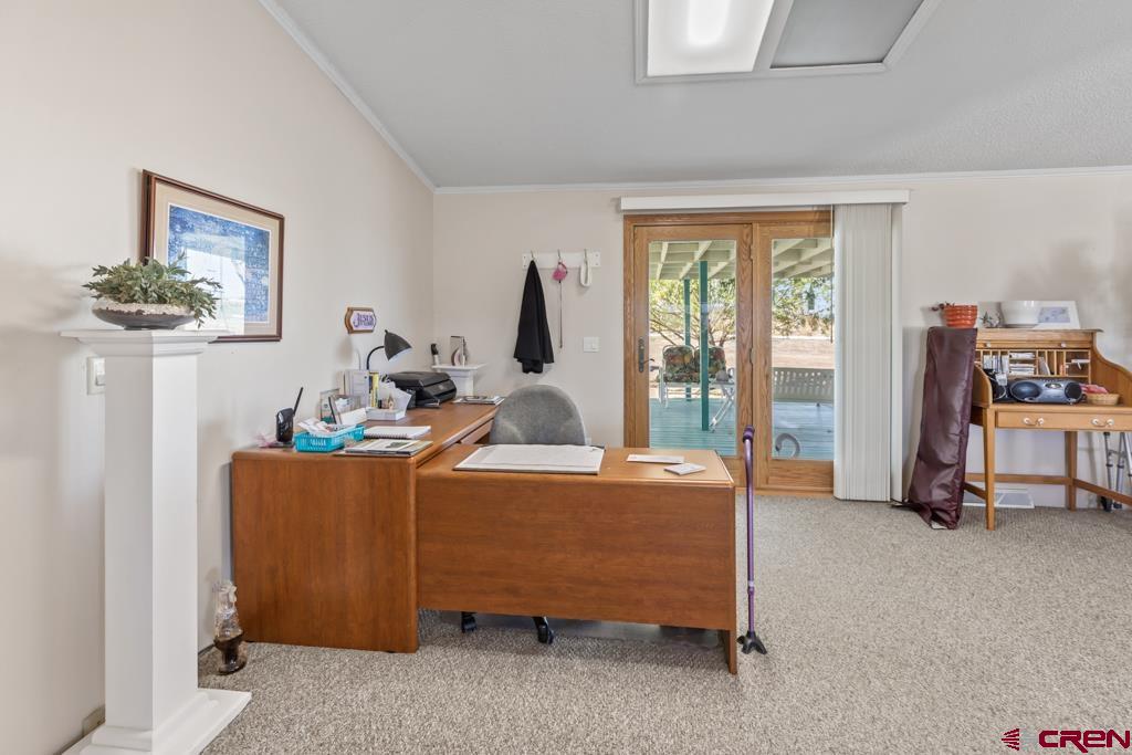 7655 6075th Road Olathe, CO 81425 - Photo 15 of 24 a bed room with furniture and a window