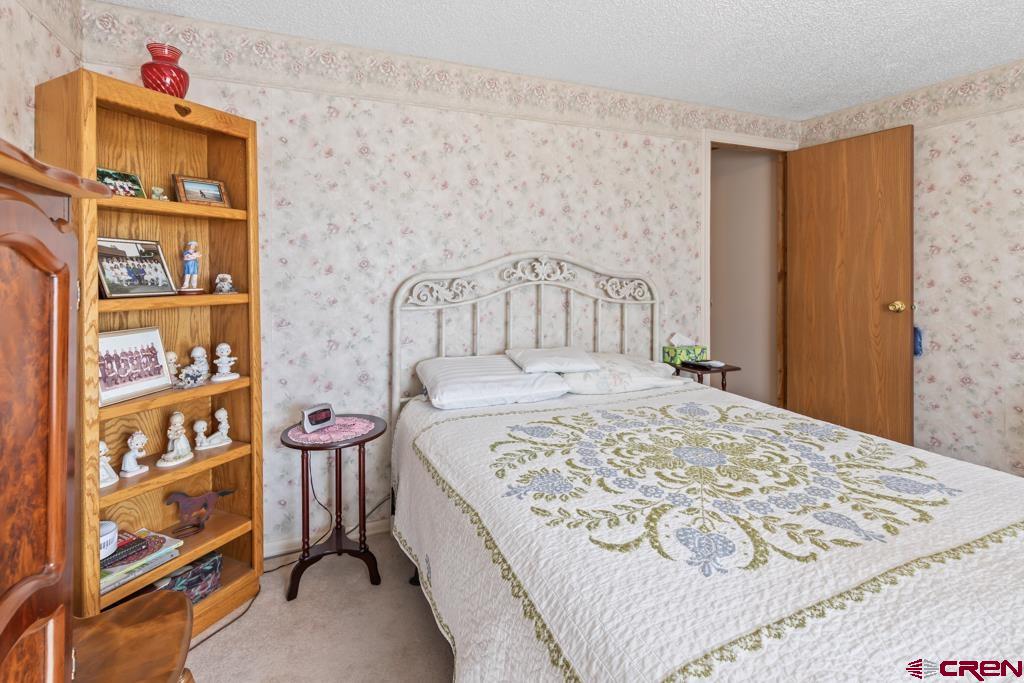 7655 6075th Road Olathe, CO 81425 - Photo 20 of 24 a bedroom with a bed and a window