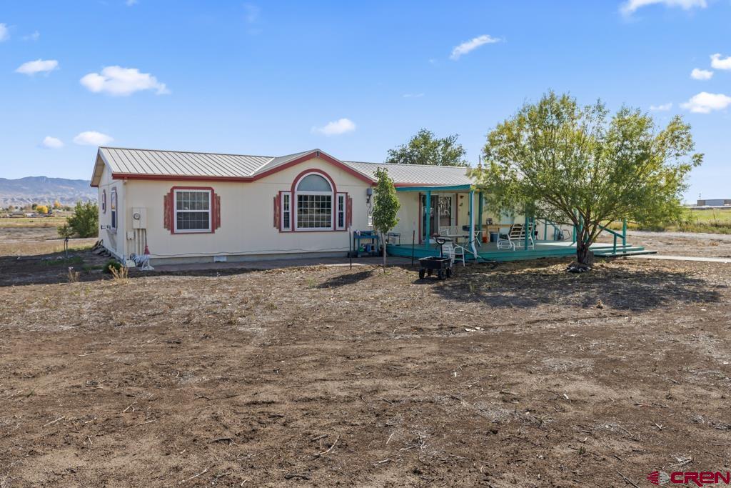 7655 6075th Road Olathe, CO 81425 - Photo 22 of 24 a view of house with yard