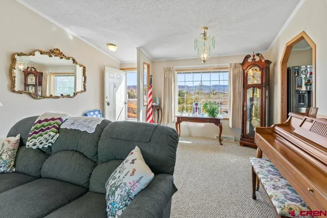 a living room with furniture and a chandelier
