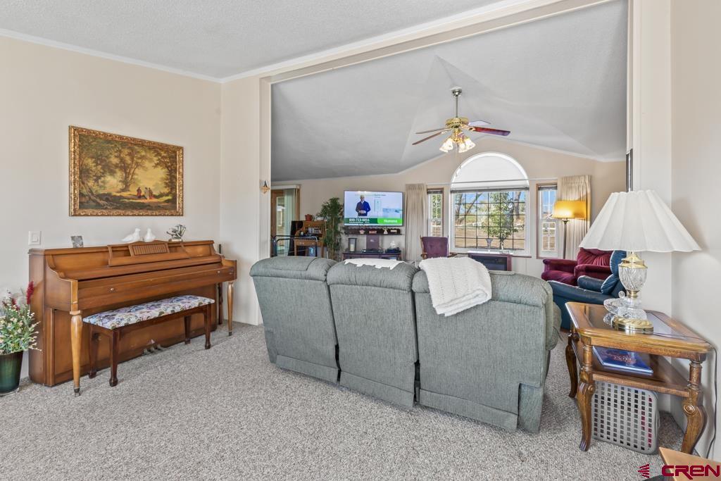7655 6075th Road Olathe, CO 81425 - Photo 7 of 24 a living room with furniture a chandelier and a window