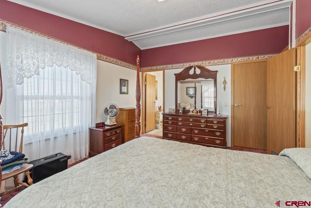 7655 6075th Road Olathe, CO 81425 - Photo 10 of 24 a bedroom with a bed and a dresser