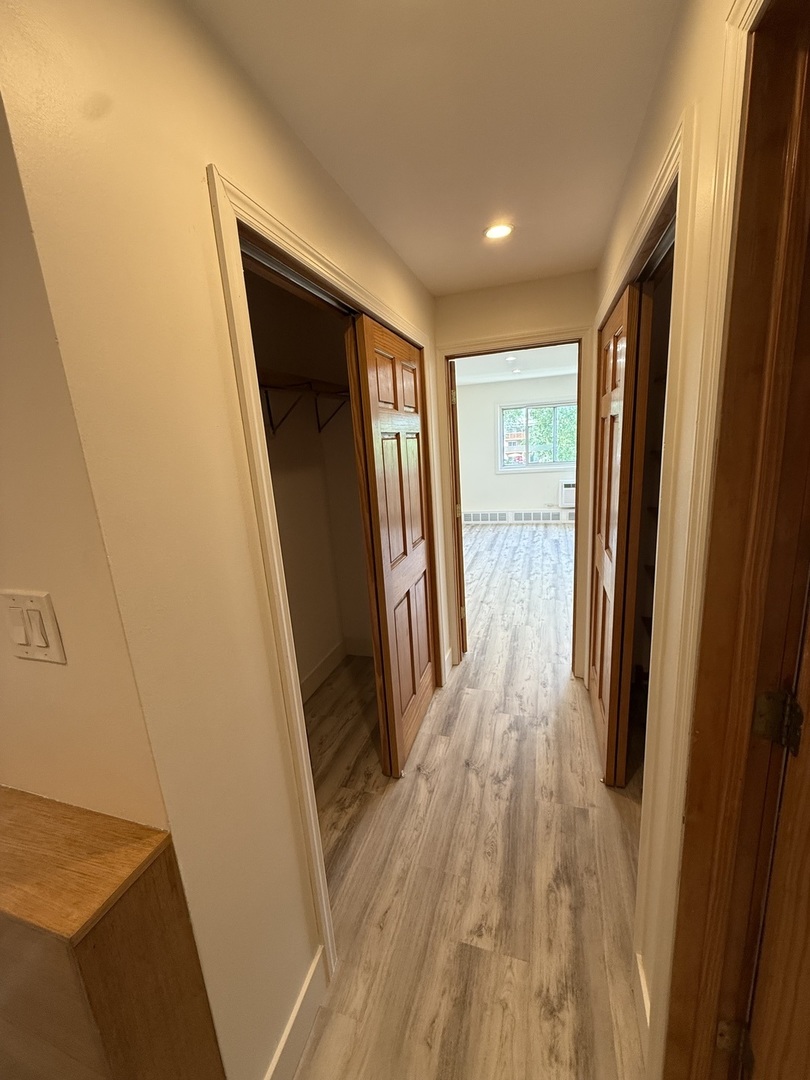 728 Dempster Street, Unit 210 Mount Prospect, IL 60056 - Photo 15 of 27 a view of hallway with wooden floor and stairs