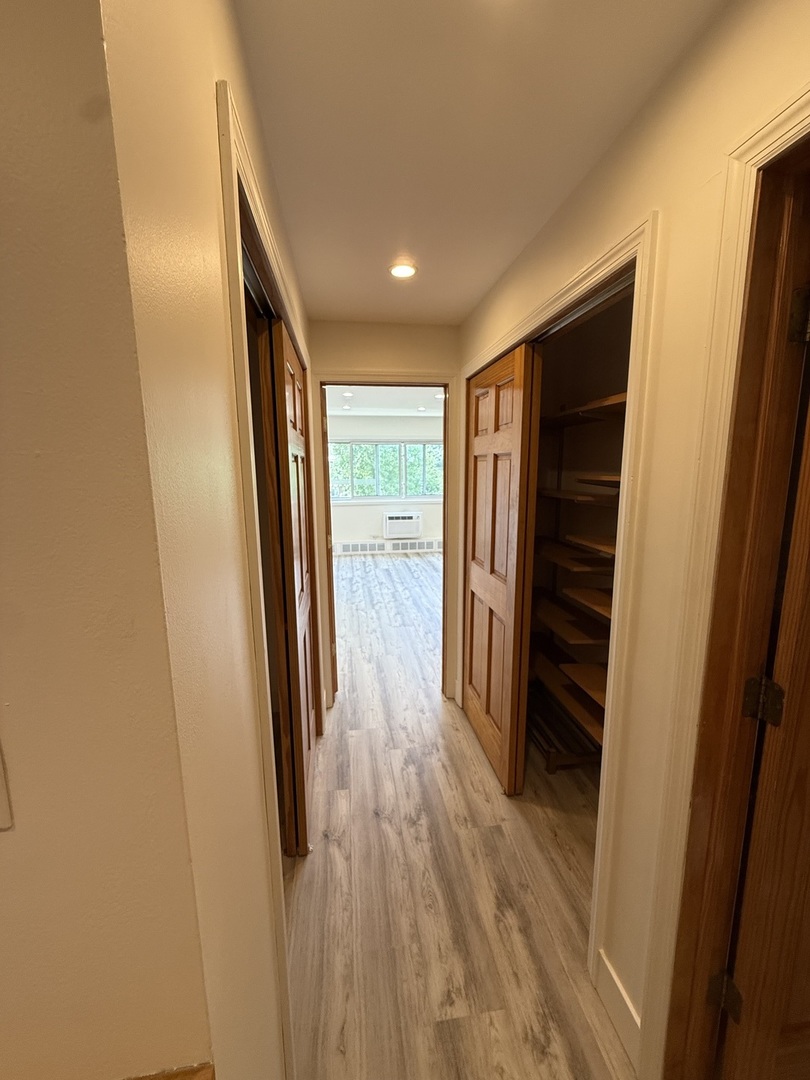 728 Dempster Street, Unit 210 Mount Prospect, IL 60056 - Photo 16 of 27 a view of hallway with wooden floor and stairs