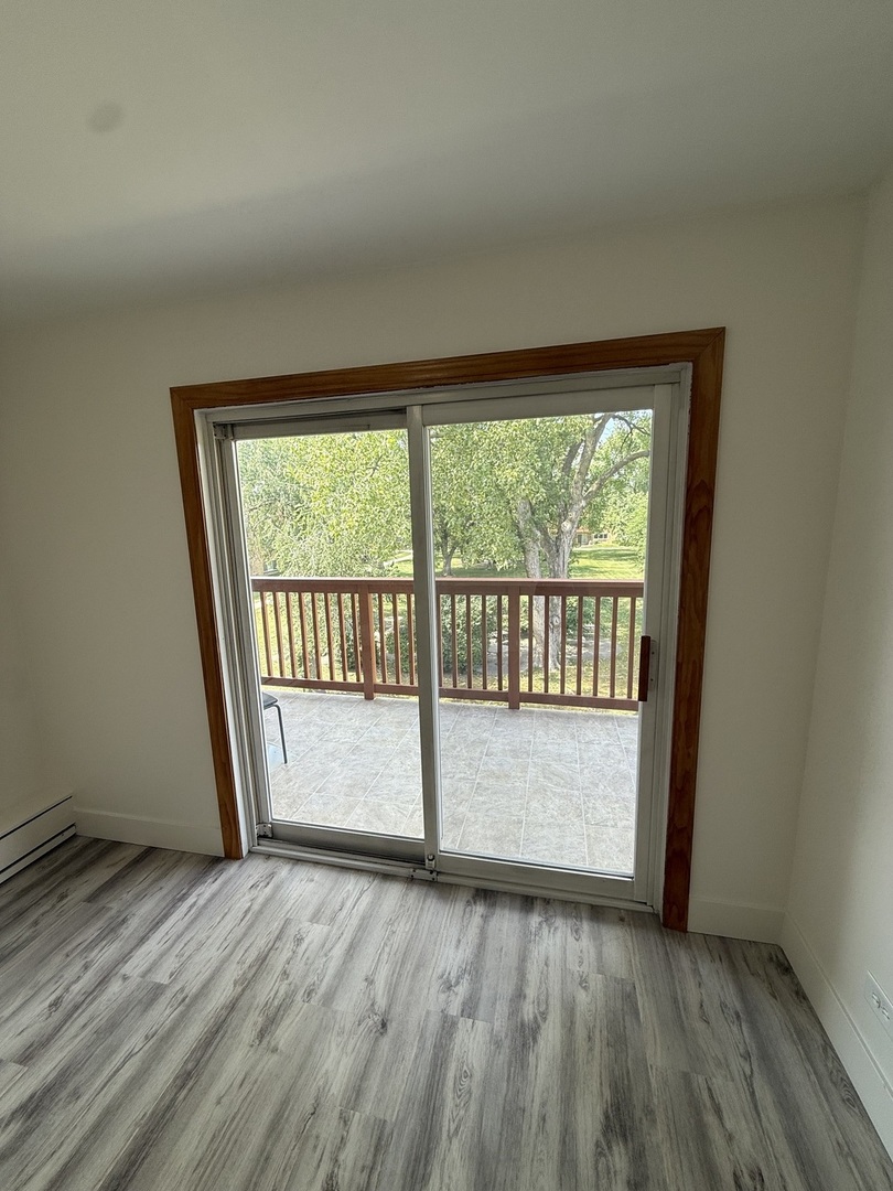 728 Dempster Street, Unit 210 Mount Prospect, IL 60056 - Photo 22 of 27 a view of empty room with wooden floor and fan