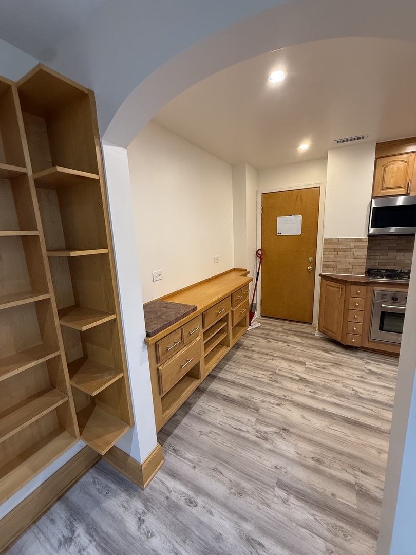 728 Dempster Street, Unit 210 Mount Prospect, IL 60056 - Photo 8 of 27 a view of a room with wooden floor and a window