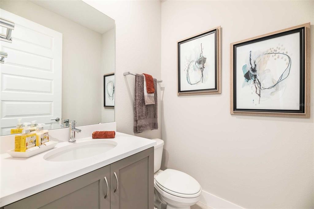 7905 Spectrum Drive Kissimmee, FL 34747 - Photo 6 of 12 a bathroom with a toilet a sink and a mirror