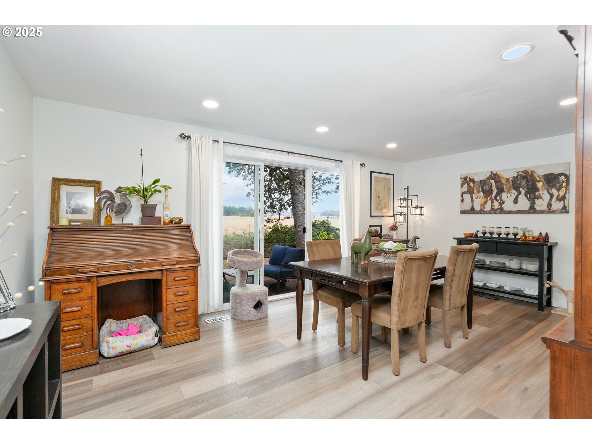1780 Clover Ridge Road Northeast Albany, OR 97322 - Photo 17 of 45 a living room with furniture a fireplace and a dining table with wooden floor