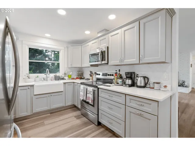 a kitchen with a sink stove and cabinets