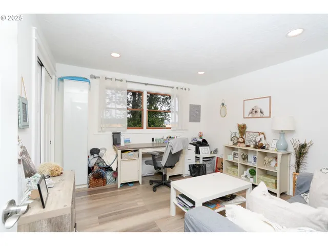 a bedroom with a bed table and a painting