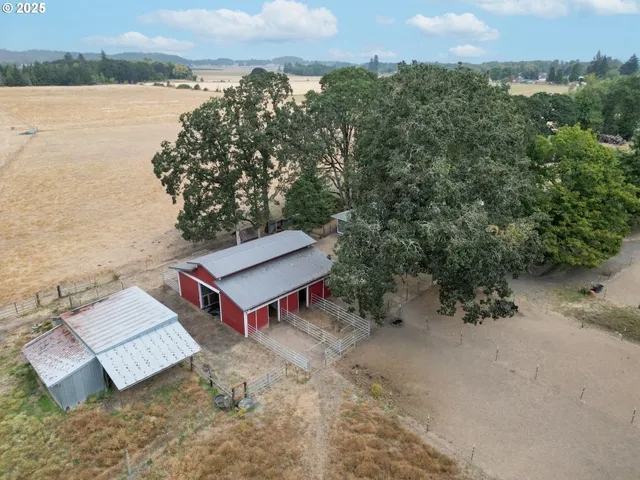 an aerial view of a house with a yard and lake view