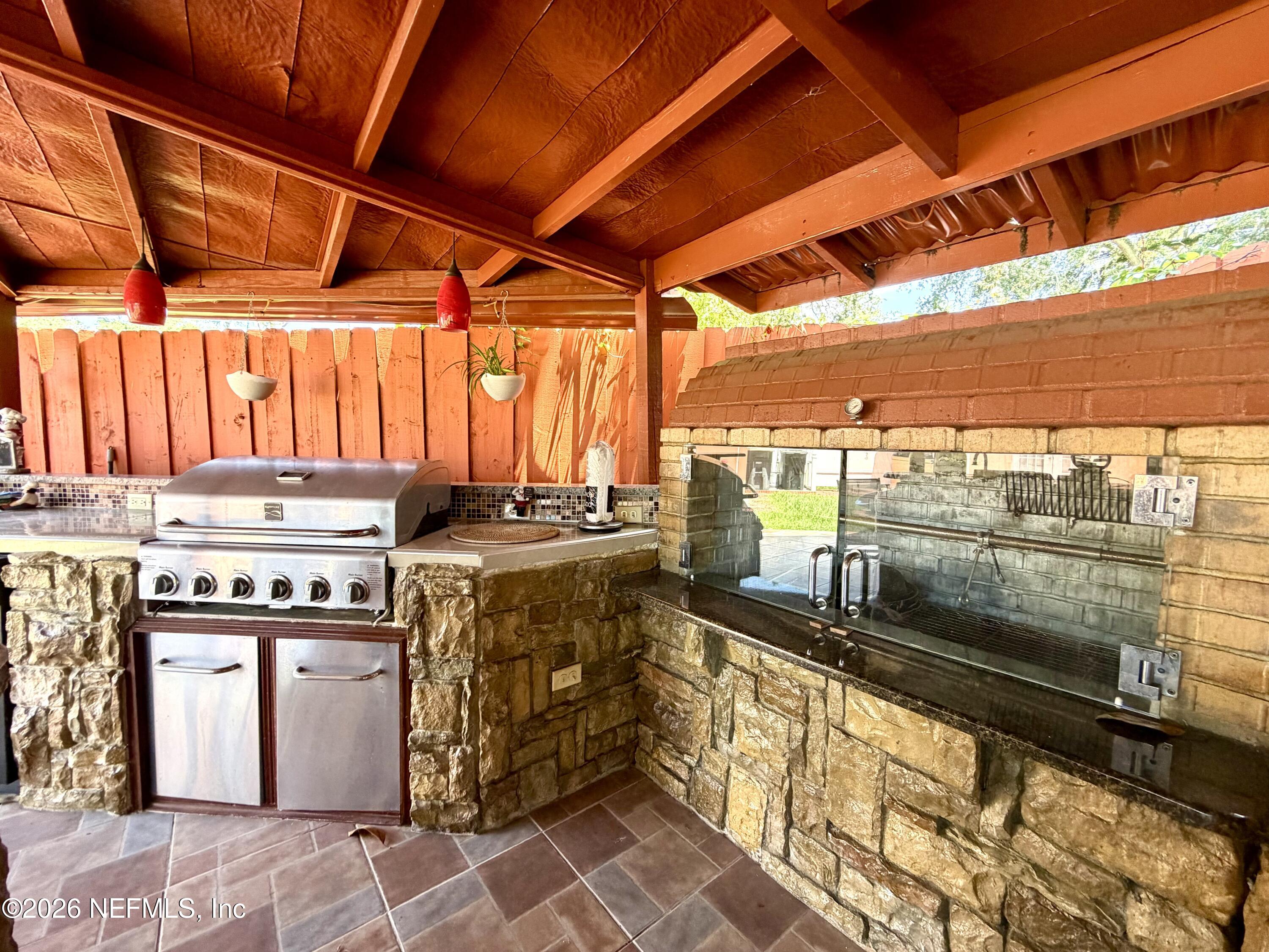 4127 Springwood Road Jacksonville, FL 32207 - Photo 46 of 63 a kitchen with a stove and a microwave