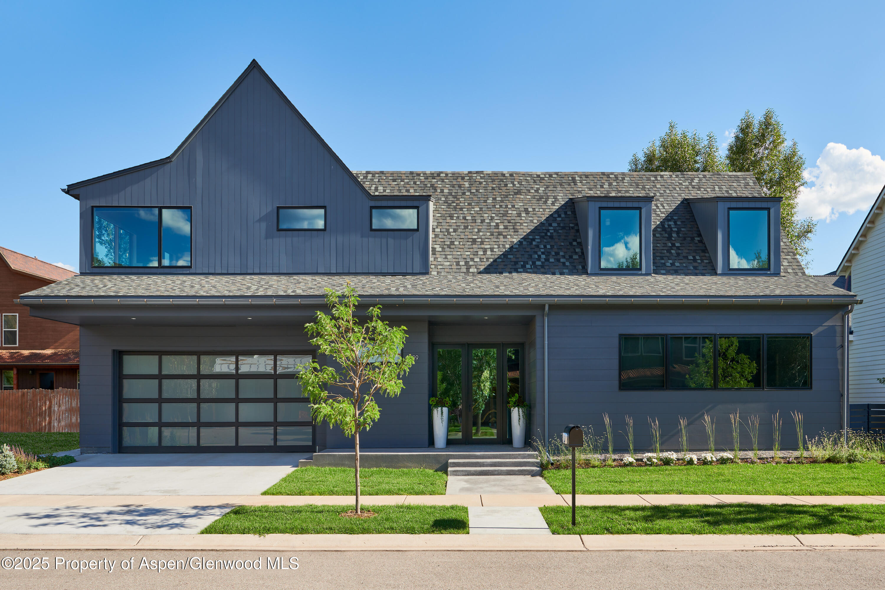 129 Valley Court Basalt, CO 81621 - Photo 1 of 26 a front view of a house with a garden and plants