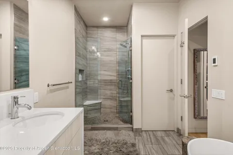 a bathroom with a sink toilet and mirror