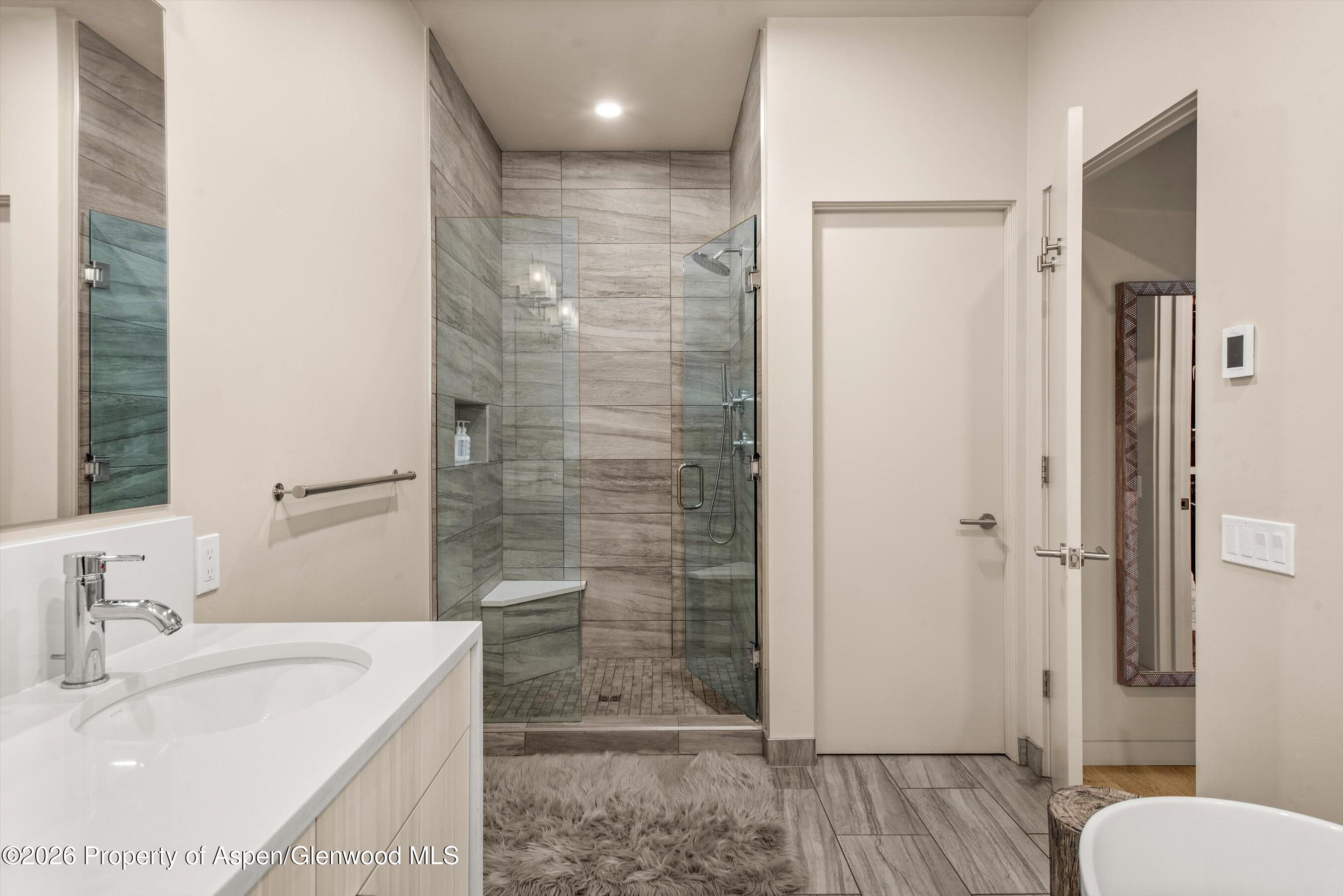 129 Valley Court Basalt, CO 81621 - Photo 16 of 26 a bathroom with a granite countertop sink toilet and shower