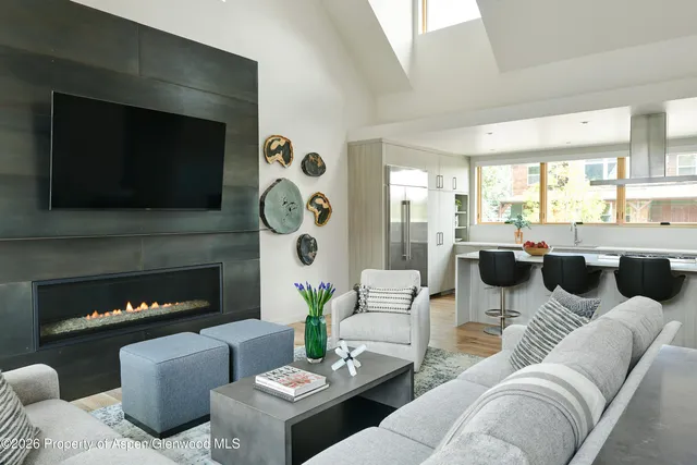 a living room with furniture a fireplace and a flat screen tv