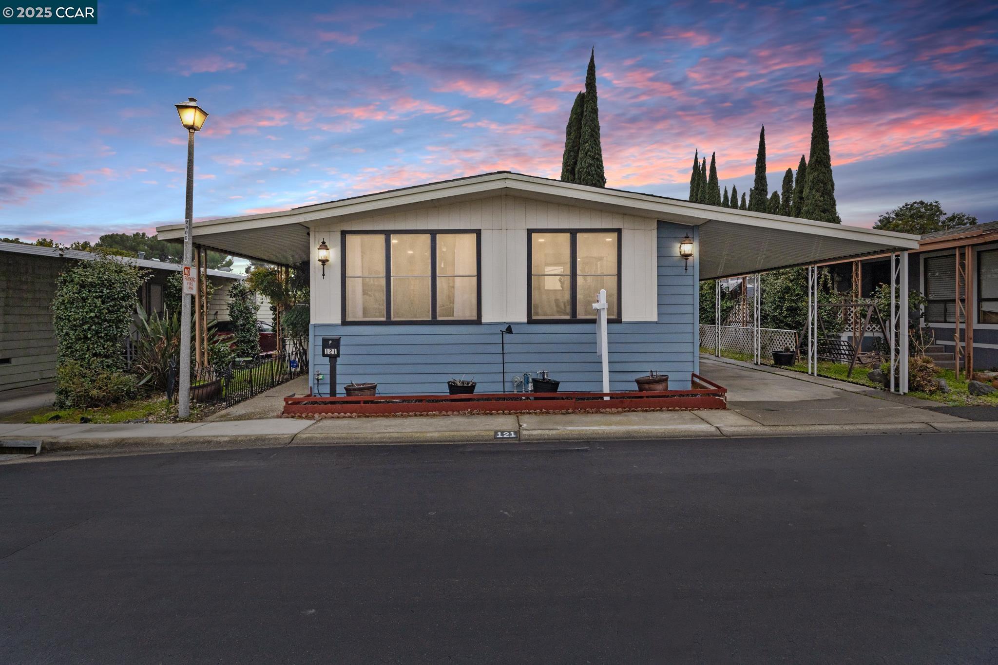 a front view of a house with a garden and street