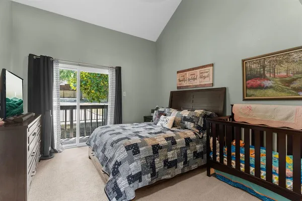 a bedroom with a bed and a flat screen tv