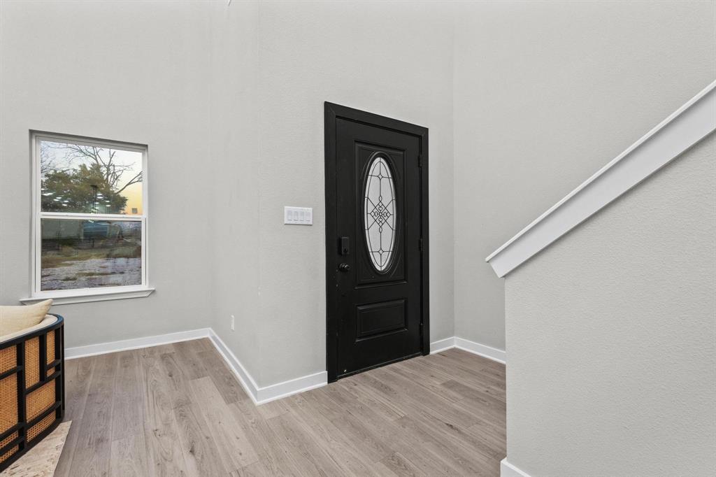 3632 County Road Blossom, TX 75416 - Photo 11 of 36 an empty room with wooden floor cabinet and window