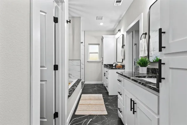 a bathroom with a double vanity sink mirror and double
