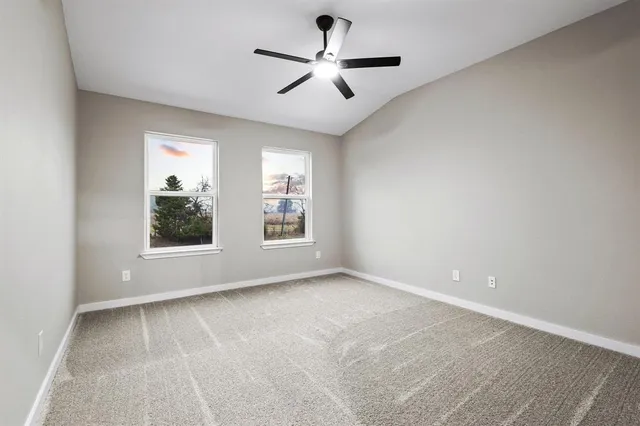 a view of room with window and ceiling fan
