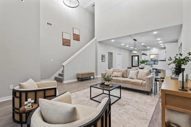 a living room with furniture kitchen view and a potted plant