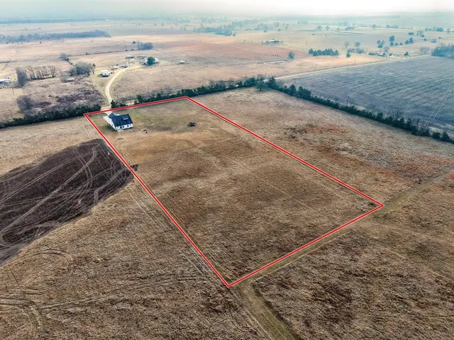a view of a house next to a lake with mountain view