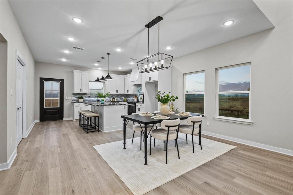 3632 County Road Blossom, TX 75416 - Photo 5 of 36 a view of a dining room and livingroom with furniture wooden floor a chandelier