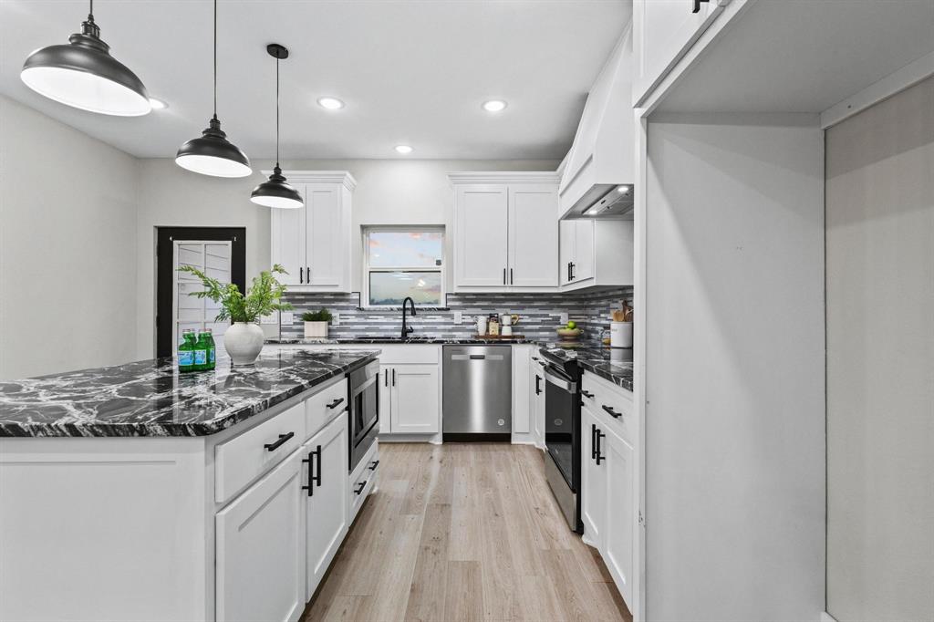 3632 County Road Blossom, TX 75416 - Photo 9 of 36 a kitchen with stainless steel appliances granite countertop a sink a stove and a refrigerator