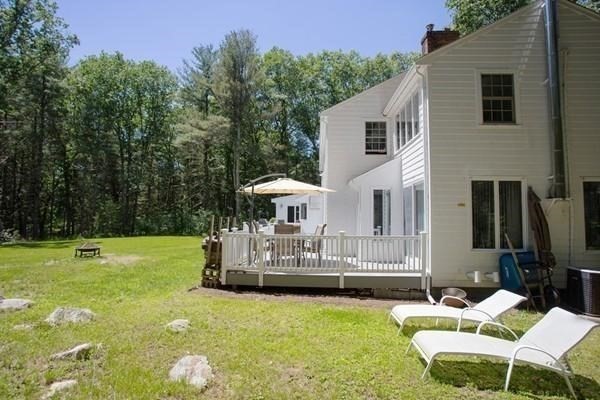 61 3 Ponds Road Wayland, MA 01778 - Photo 25 of 33 a view of a house with backyard and sitting area
